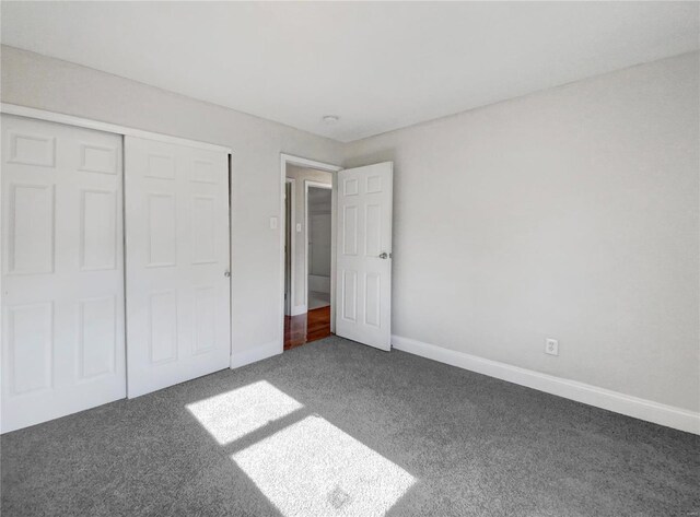 unfurnished bedroom with a closet and carpet floors