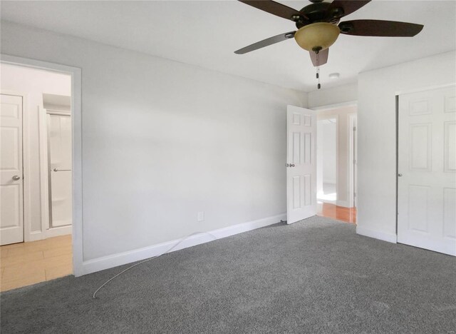 unfurnished bedroom featuring ceiling fan and light carpet