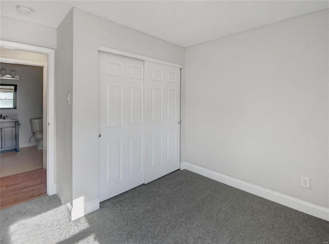 unfurnished bedroom with a closet and wood-type flooring