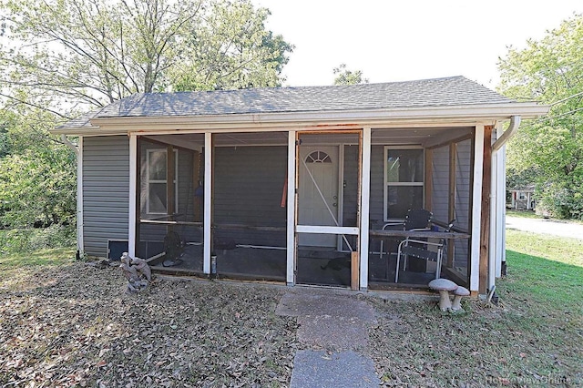 view of outdoor structure featuring a sunroom