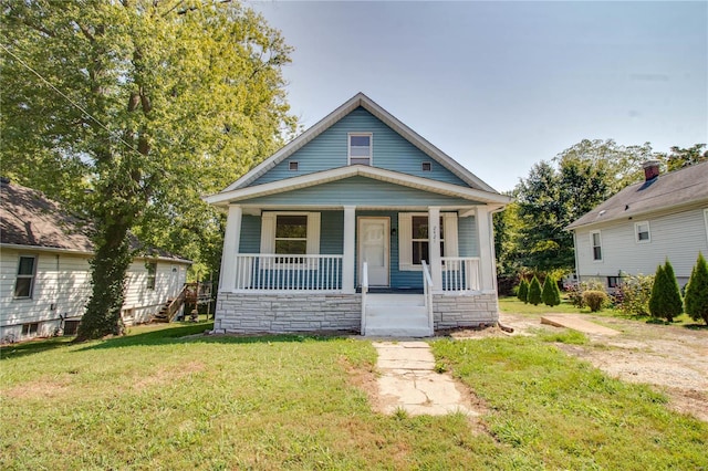 bungalow-style home featuring a porch and a front lawn