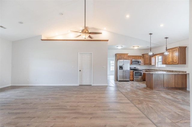 kitchen featuring lofted ceiling, ceiling fan, stainless steel appliances, and light hardwood / wood-style flooring