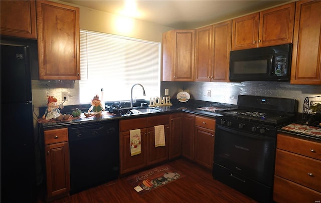 kitchen featuring black appliances, tasteful backsplash, sink, and dark hardwood / wood-style floors