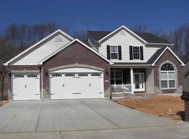 view of front of property featuring a garage and a porch