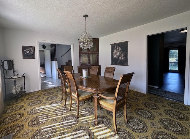 dining room with a notable chandelier and a textured ceiling