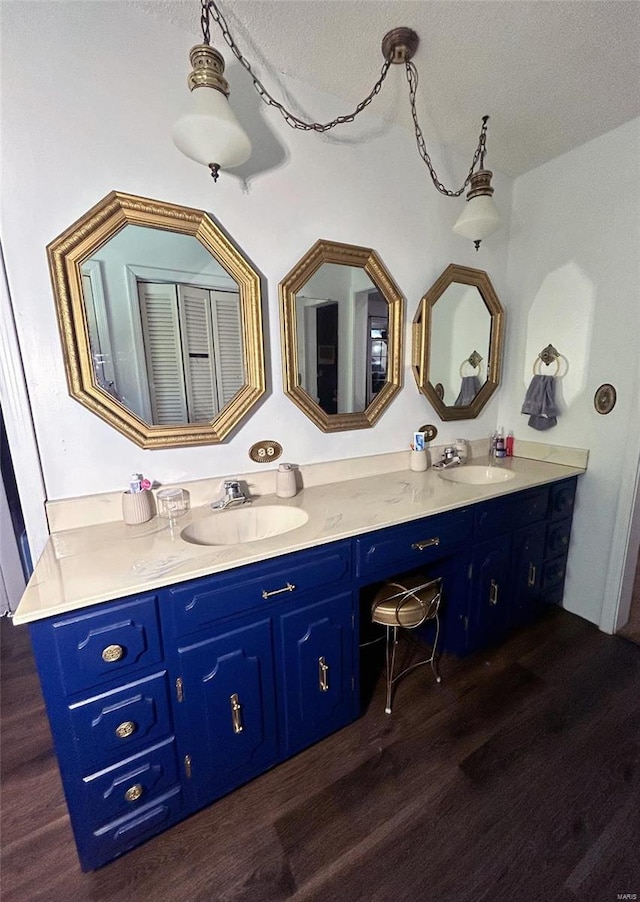 bathroom with vanity, hardwood / wood-style floors, and a textured ceiling