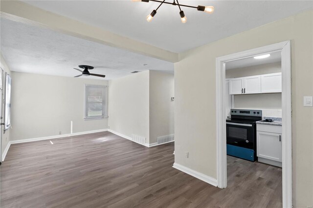 unfurnished living room with a healthy amount of sunlight and dark hardwood / wood-style floors