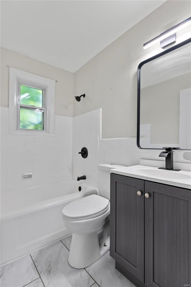 full bathroom featuring tiled shower / bath combo, vanity, toilet, and tile patterned flooring