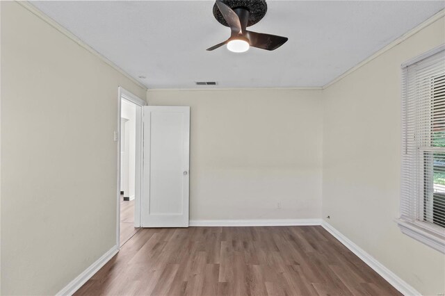 spare room featuring ornamental molding, hardwood / wood-style flooring, and ceiling fan