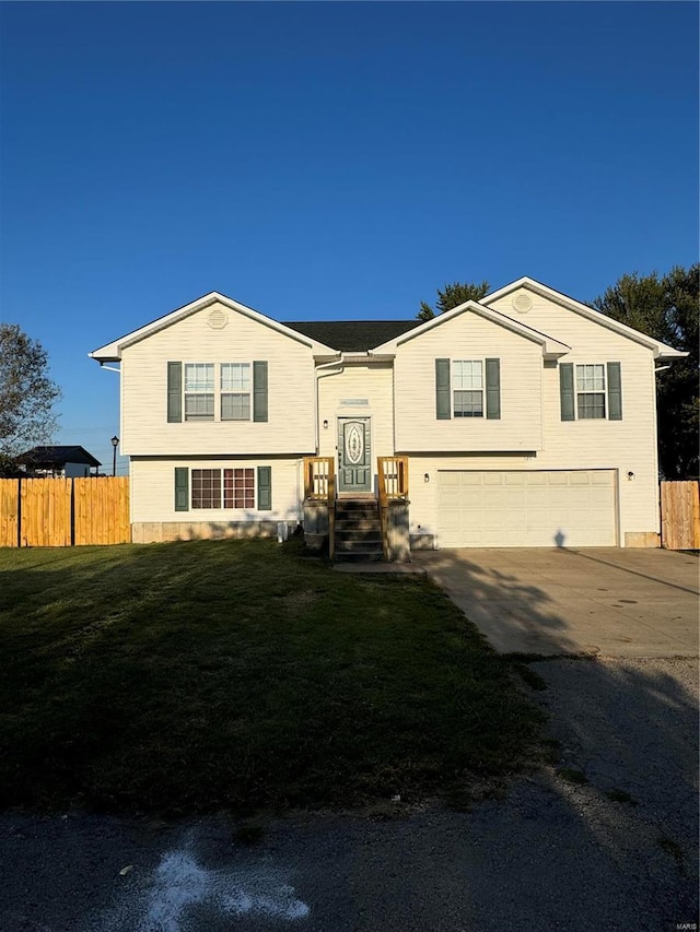 view of front of home with a garage and a front lawn