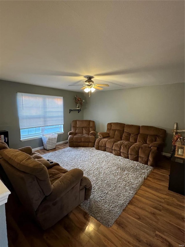 living room with wood-type flooring and ceiling fan