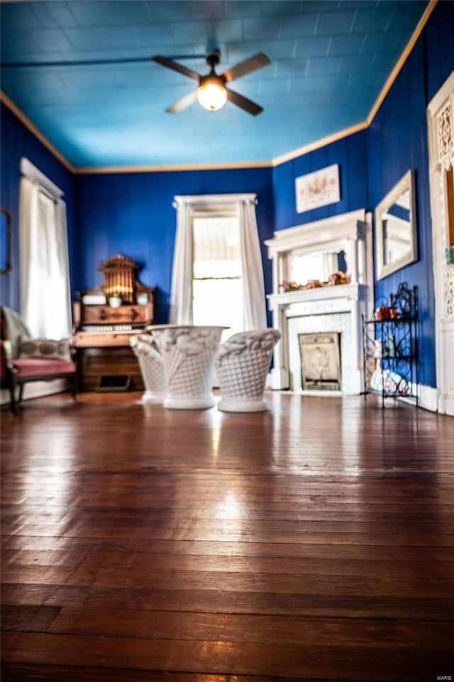 living room with ceiling fan, ornamental molding, and dark hardwood / wood-style flooring