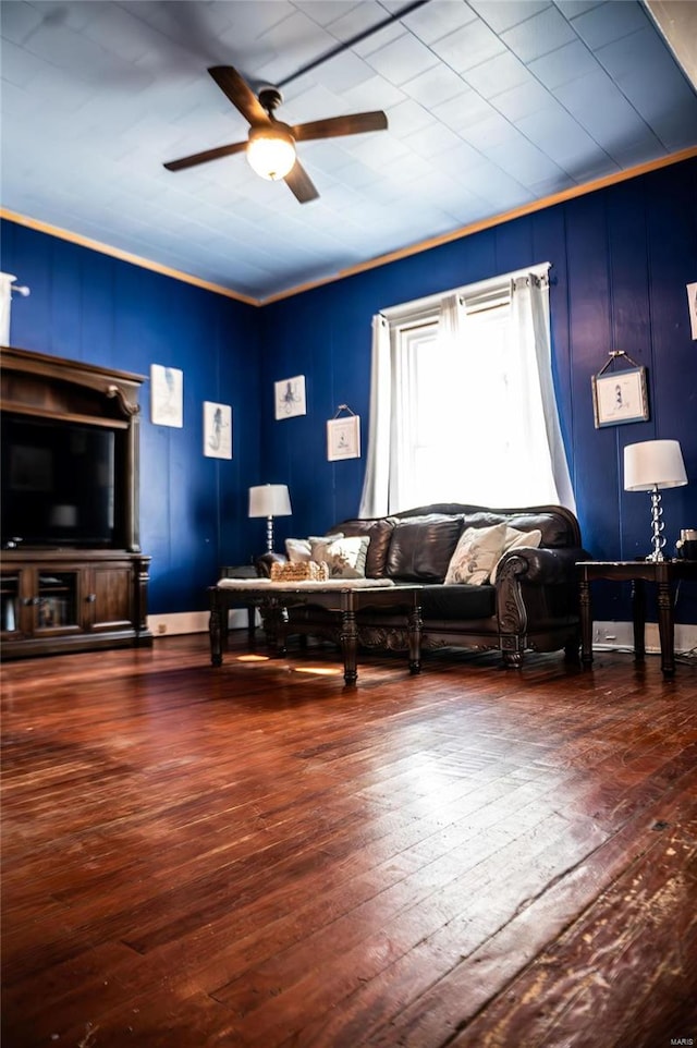 living room with ceiling fan, dark hardwood / wood-style floors, and ornamental molding