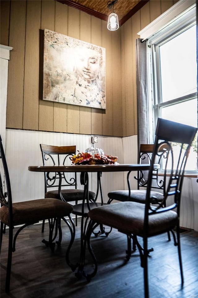 dining area with wood ceiling, wood walls, and wood-type flooring