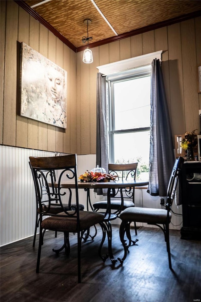 dining room with wooden ceiling and wooden walls