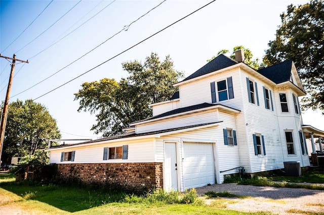 view of property exterior featuring a garage and cooling unit