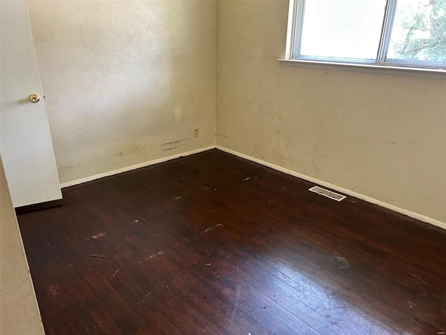 empty room with dark hardwood / wood-style floors