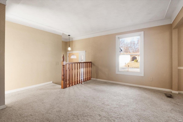 carpeted empty room featuring visible vents and baseboards