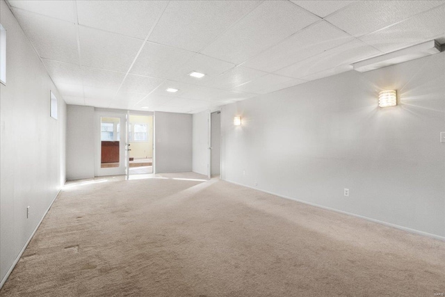 empty room featuring a drop ceiling and carpet floors