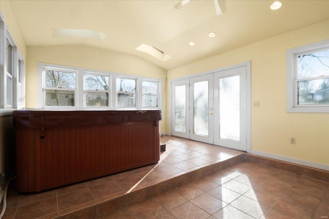 interior space with lofted ceiling with skylight, recessed lighting, and baseboards