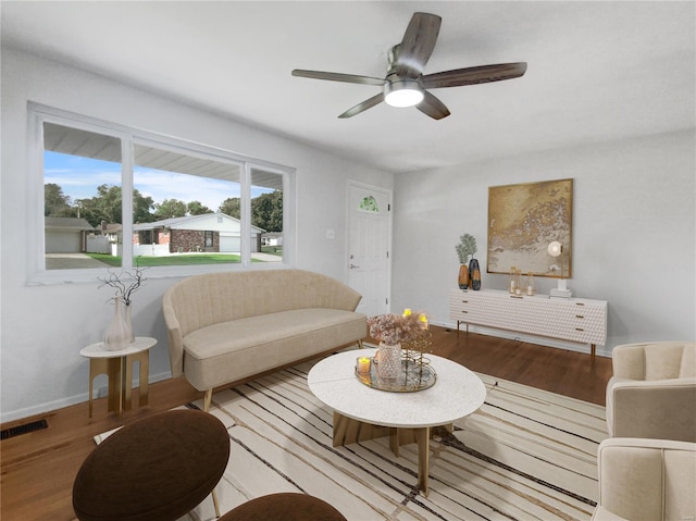 living room featuring a wealth of natural light, light hardwood / wood-style flooring, and ceiling fan