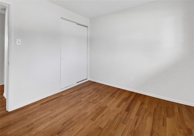 spare room with hardwood / wood-style floors