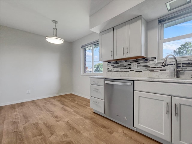 kitchen featuring white cabinetry, light hardwood / wood-style flooring, backsplash, dishwasher, and sink