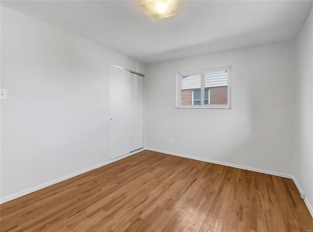 spare room with hardwood / wood-style flooring