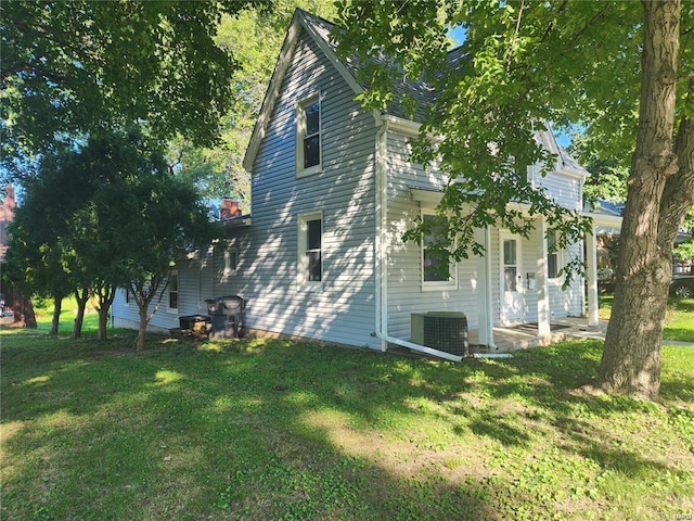 view of side of home with a lawn