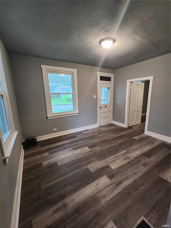 unfurnished bedroom featuring dark wood-type flooring