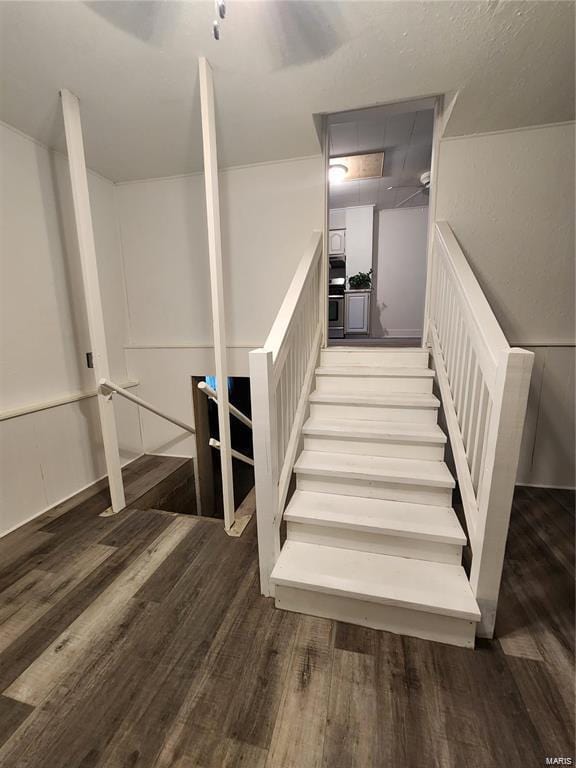 staircase with hardwood / wood-style flooring