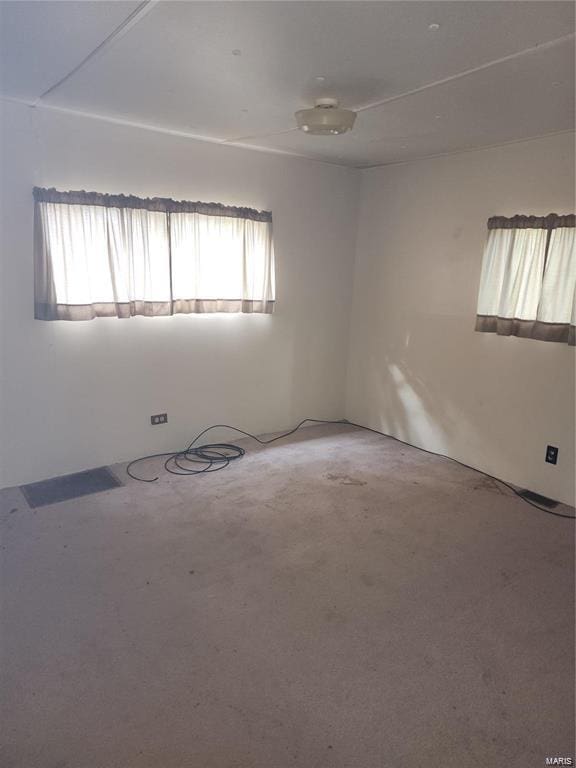 unfurnished room with plenty of natural light and concrete floors