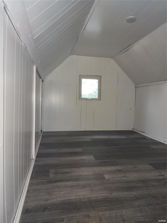 bonus room featuring dark hardwood / wood-style floors and vaulted ceiling