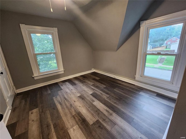 bonus room featuring dark hardwood / wood-style flooring and vaulted ceiling