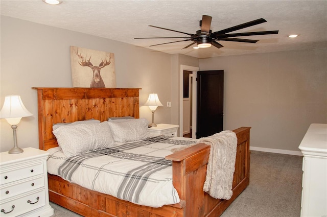 bedroom with a textured ceiling, light carpet, and ceiling fan