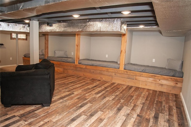 basement with hardwood / wood-style flooring