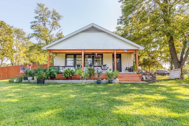 bungalow with a front yard and a porch