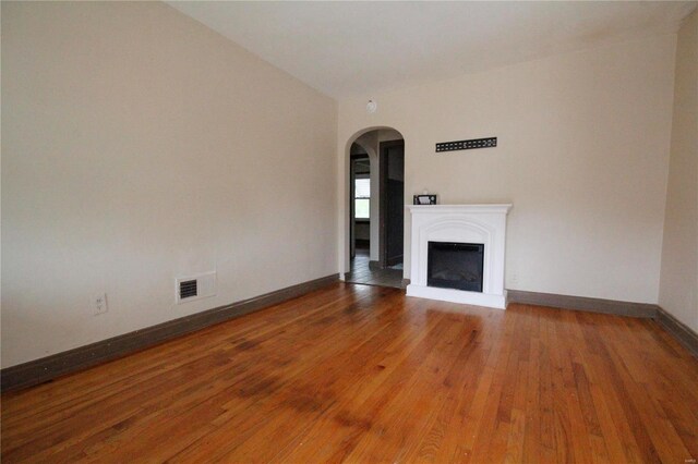 unfurnished living room featuring wood-type flooring