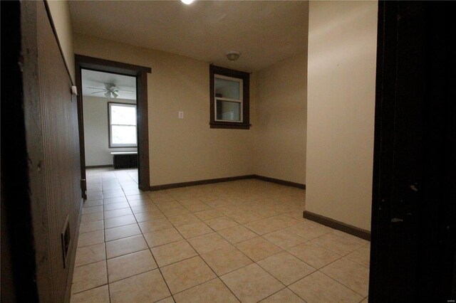 spare room with light tile patterned floors and ceiling fan