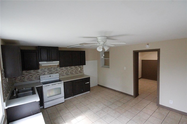 kitchen with white electric range oven, light countertops, backsplash, a sink, and under cabinet range hood