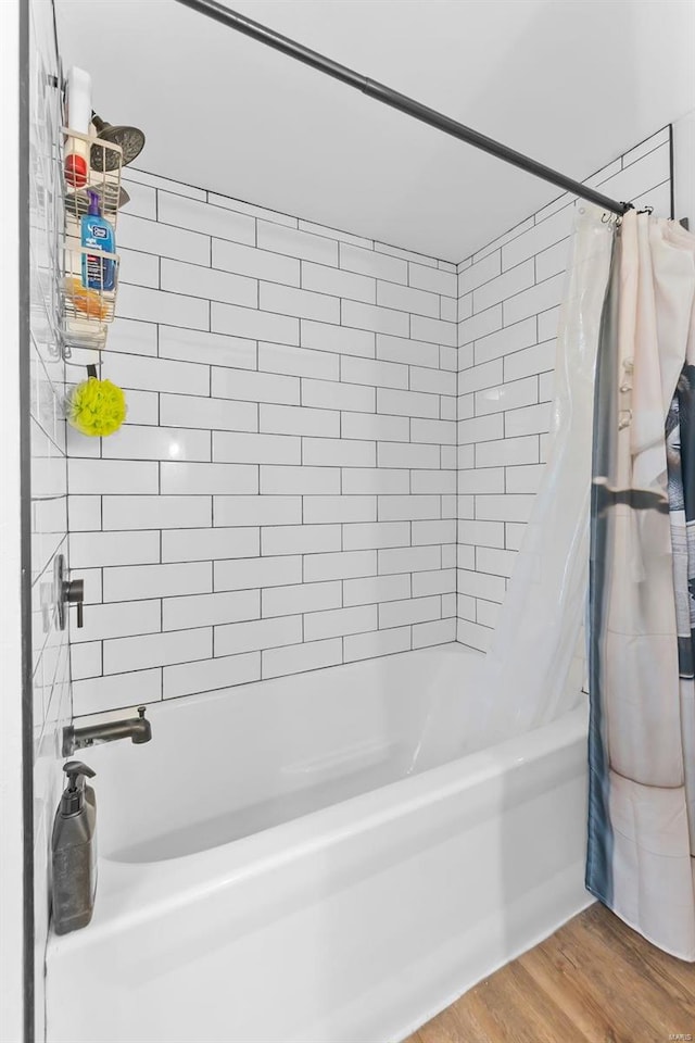 bathroom with shower / tub combo with curtain and hardwood / wood-style flooring