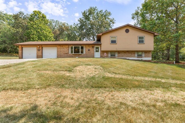 tri-level home with a garage and a front lawn