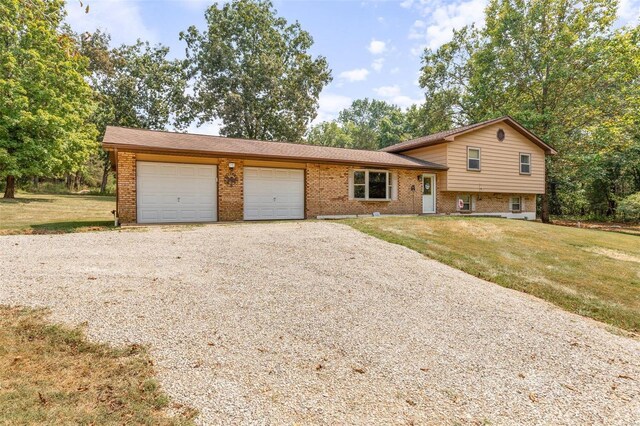 tri-level home featuring a garage and a front yard