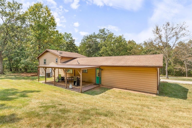 back of property featuring a lawn and a patio