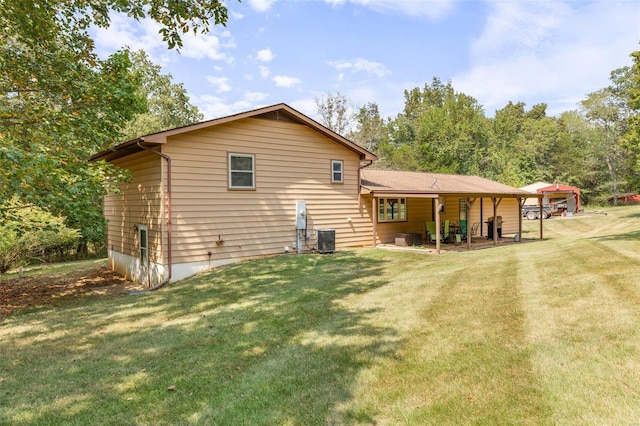 rear view of house featuring central air condition unit, a lawn, and a patio area