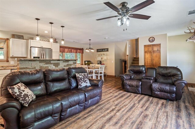 living room featuring ceiling fan and wood-type flooring