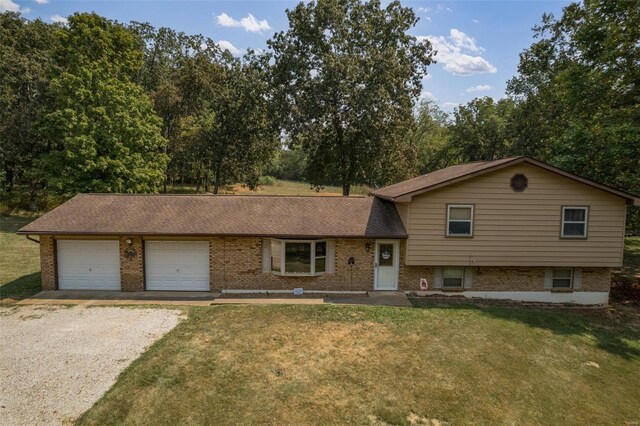 tri-level home with a garage and a front yard