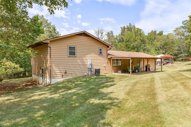 rear view of property featuring a yard and cooling unit