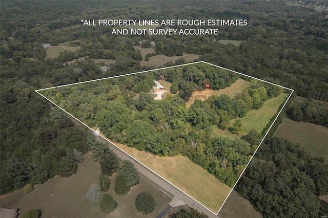 birds eye view of property with a view of trees