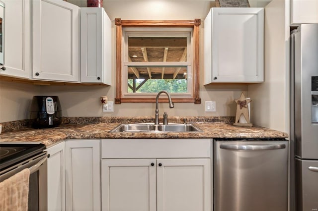 kitchen featuring a sink, white cabinetry, and stainless steel appliances